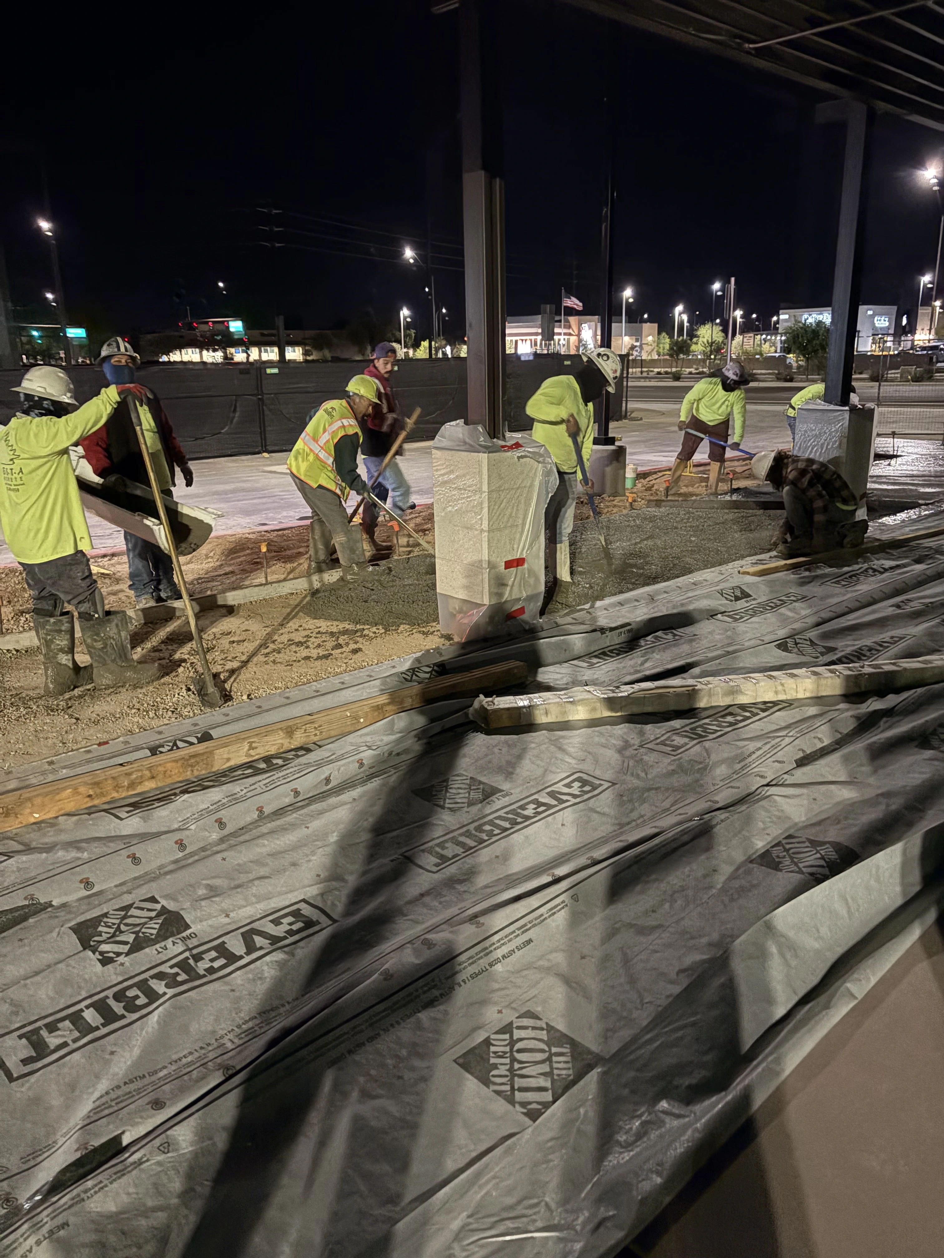 Concrete contractor crew finishing commercial concrete pour in Phoenix Arizona